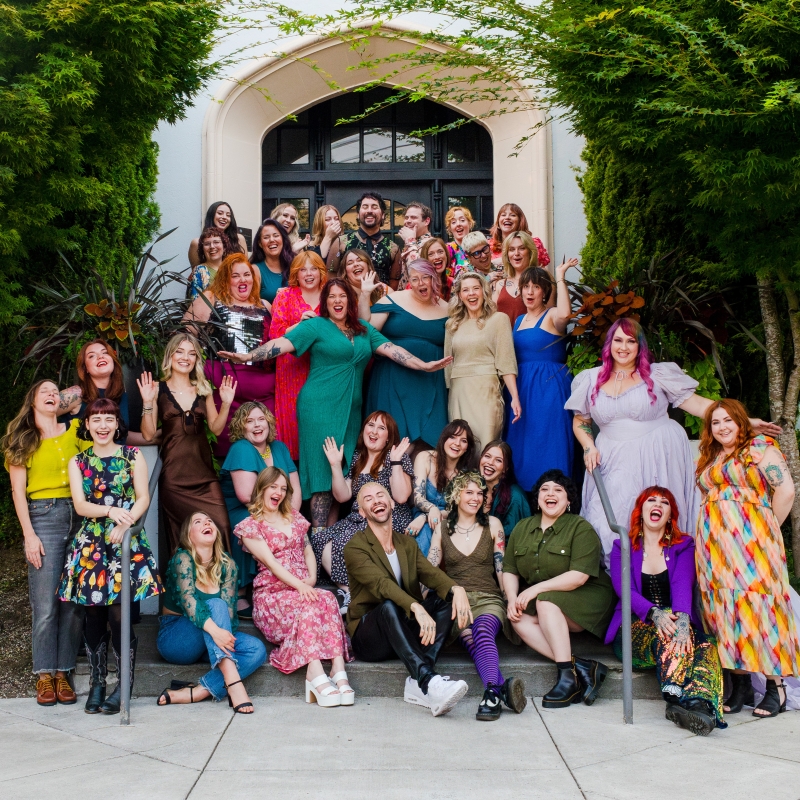 Ginger & Maude Hair Salon team members looking joyful on some city steps.