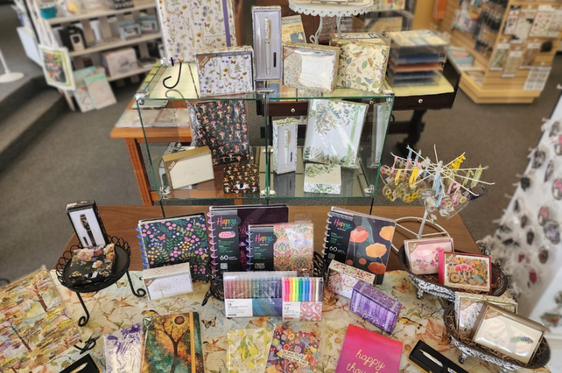 A display of notebooks, pens, and giftables from Main Street Stamp and Stationery.